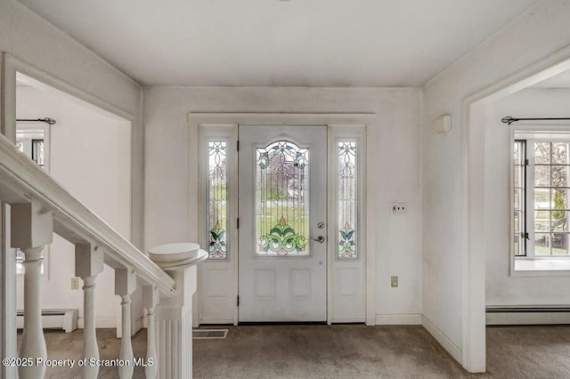 carpeted entrance foyer with baseboards, a baseboard radiator, and visible vents