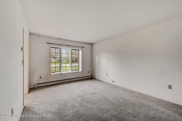 carpeted spare room with baseboards and a baseboard radiator