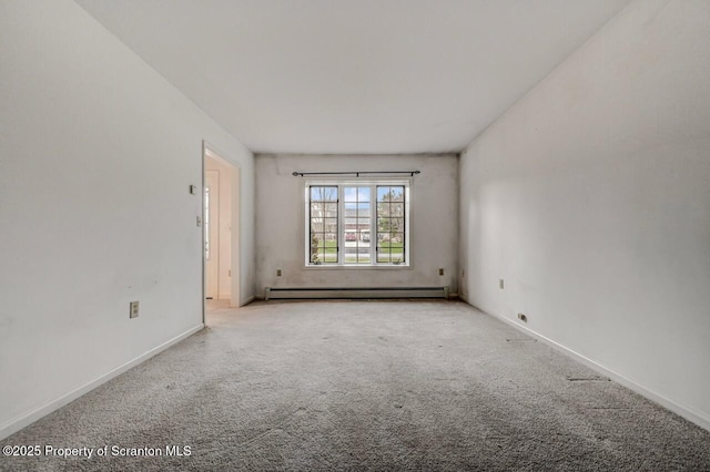 unfurnished room with baseboards, baseboard heating, and carpet floors