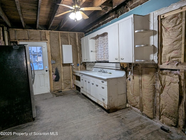 kitchen featuring sink, white cabinets, stainless steel refrigerator, and light hardwood / wood-style floors