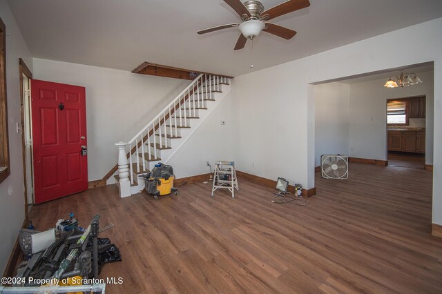 foyer entrance featuring ceiling fan with notable chandelier and dark hardwood / wood-style floors