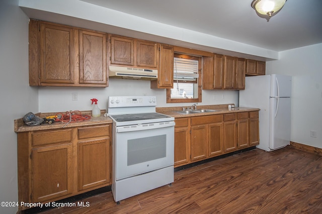 kitchen with sink, dark wood-type flooring, and white appliances