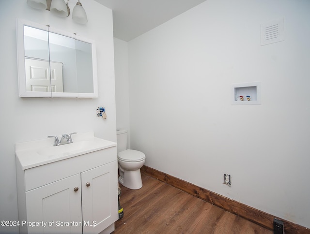 bathroom featuring hardwood / wood-style floors, vanity, and toilet