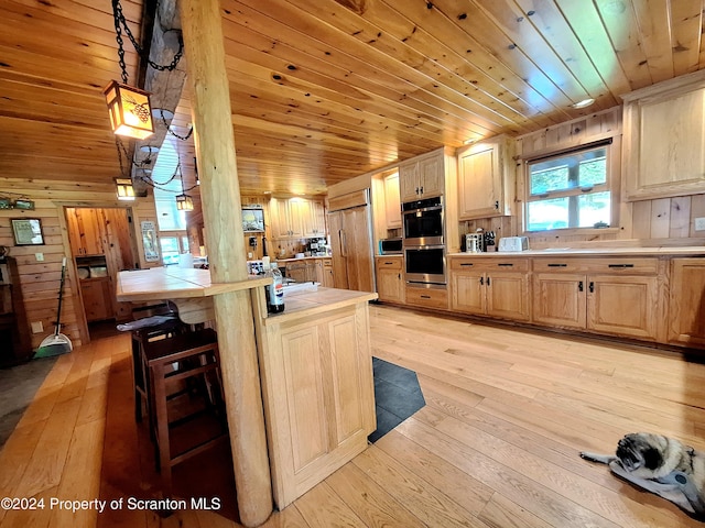 kitchen with light wood-type flooring, light brown cabinetry, decorative light fixtures, wood ceiling, and stainless steel appliances