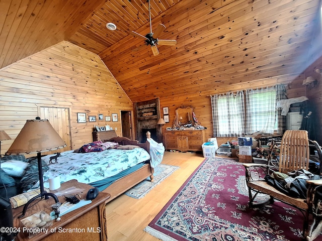 bedroom with wooden walls, wood ceiling, and wood-type flooring