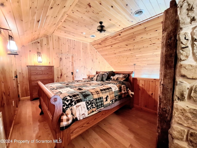 bedroom featuring lofted ceiling, light hardwood / wood-style flooring, and wooden ceiling