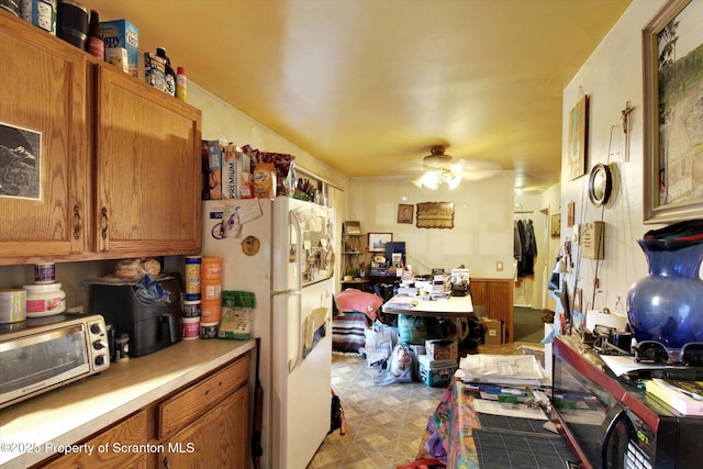 kitchen with white fridge and ceiling fan