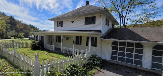 view of front of property featuring a porch and a garage