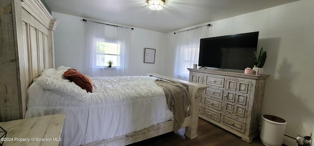 bedroom with dark hardwood / wood-style floors