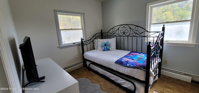 carpeted bedroom with baseboard heating and multiple windows