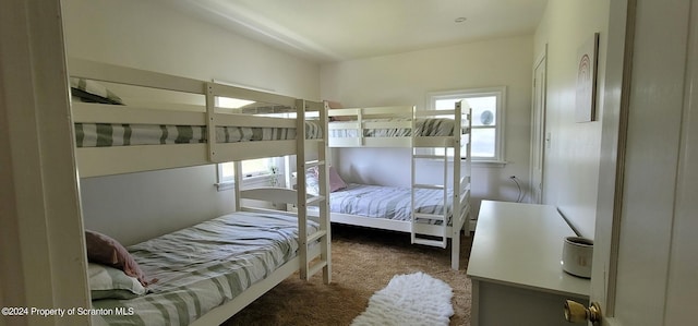 bedroom with carpet and multiple windows