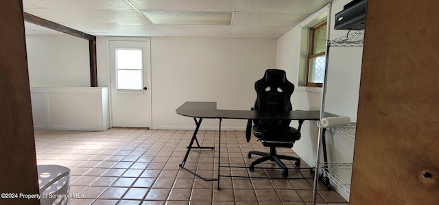 tiled office with a paneled ceiling