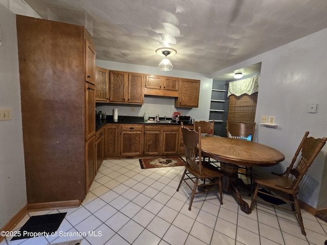 kitchen featuring light tile patterned floors and sink