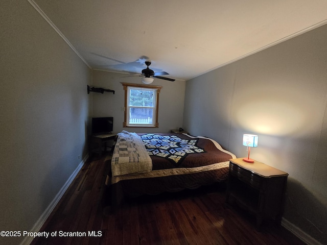 bedroom with crown molding, ceiling fan, and dark wood-type flooring