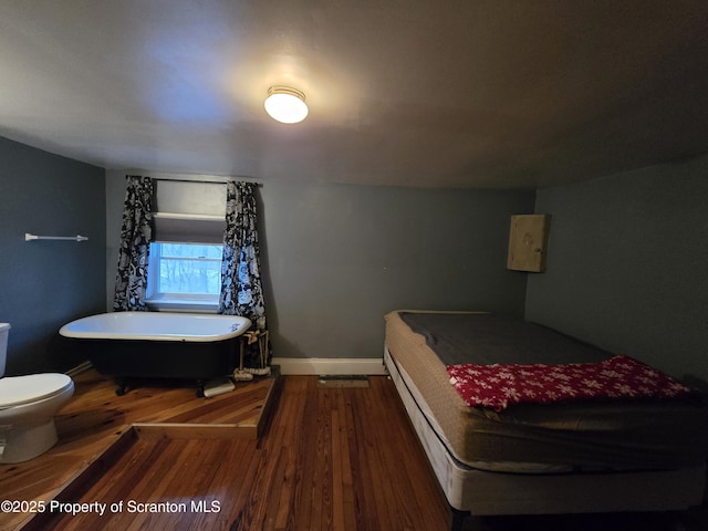 bedroom with hardwood / wood-style flooring