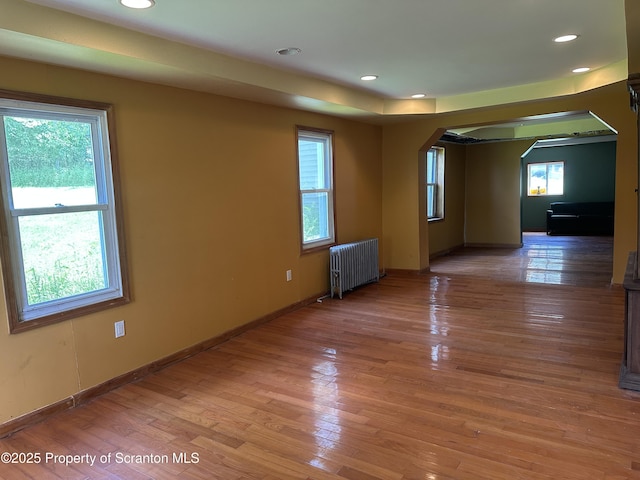 439 Old Union Rd, Equinunk, PA 18417 - unfurnished room featuring radiator heating unit, arched walkways, light wood-style flooring, and recessed lighting