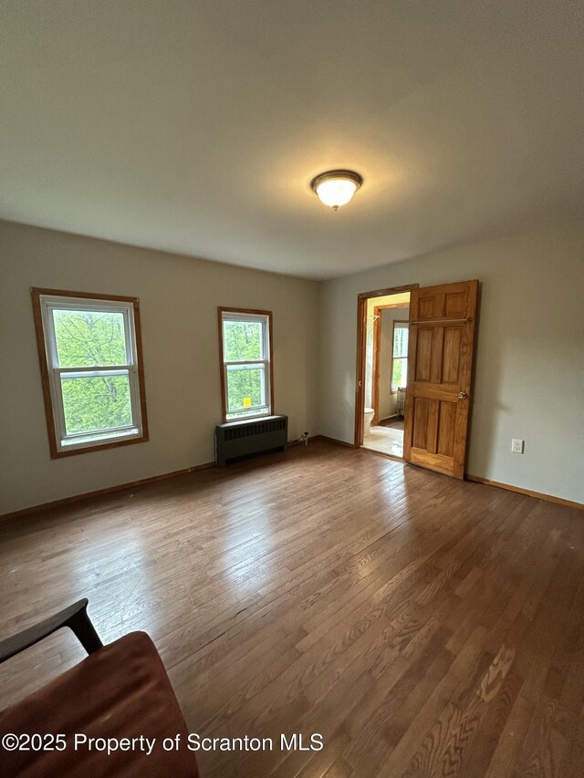 439 Old Union Rd, Equinunk, PA 18417 - unfurnished room with radiator heating unit and wood finished floors