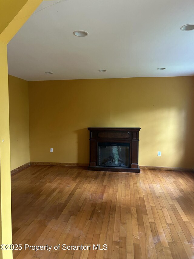 439 Old Union Rd, Equinunk, PA 18417 - unfurnished living room with light wood finished floors and a glass covered fireplace