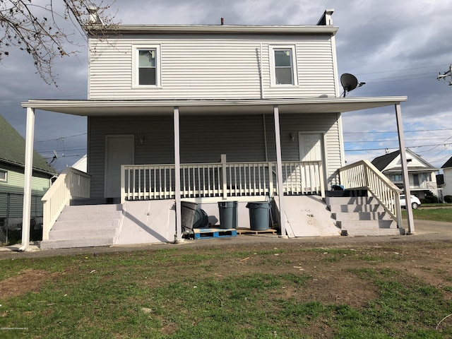 back of house featuring a porch