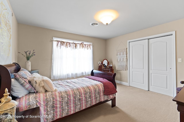 carpeted bedroom featuring a closet