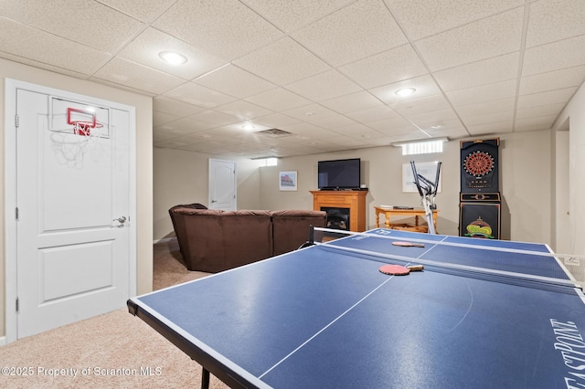 rec room with a paneled ceiling and carpet