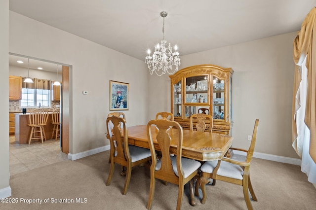 dining space with a notable chandelier and light carpet