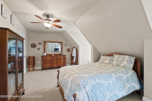 carpeted bedroom with ceiling fan and vaulted ceiling