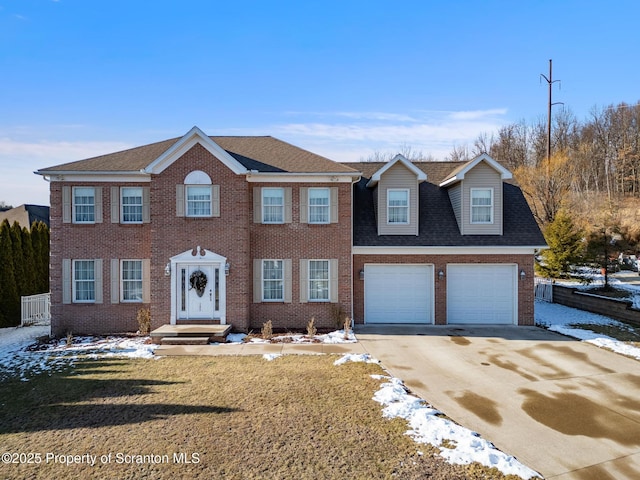 view of front of property featuring a yard and a garage