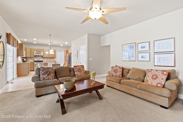 carpeted living room featuring ceiling fan