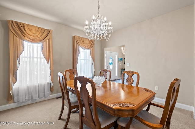 carpeted dining room with an inviting chandelier