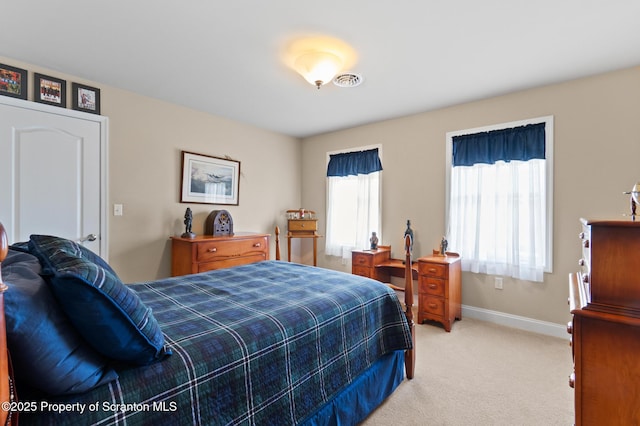 bedroom featuring light colored carpet