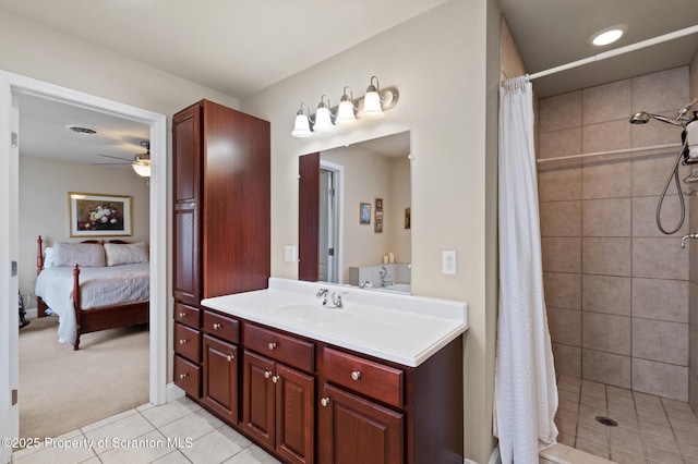 bathroom featuring tile patterned flooring, ceiling fan, a shower with shower curtain, and vanity