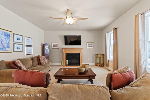 carpeted living room with ceiling fan