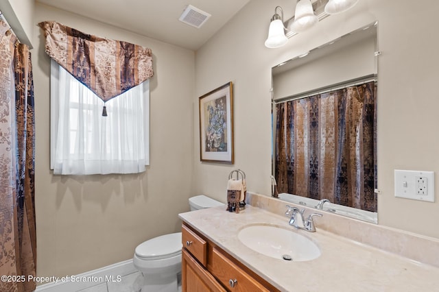 bathroom with toilet, tile patterned floors, and vanity