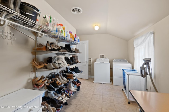 laundry room featuring washer and clothes dryer and light tile patterned flooring