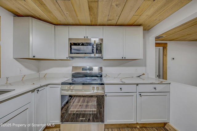 28 Holland Rd, Hawley, PA 18428 - kitchen with appliances with stainless steel finishes, wooden ceiling, white cabinets, and light stone countertops