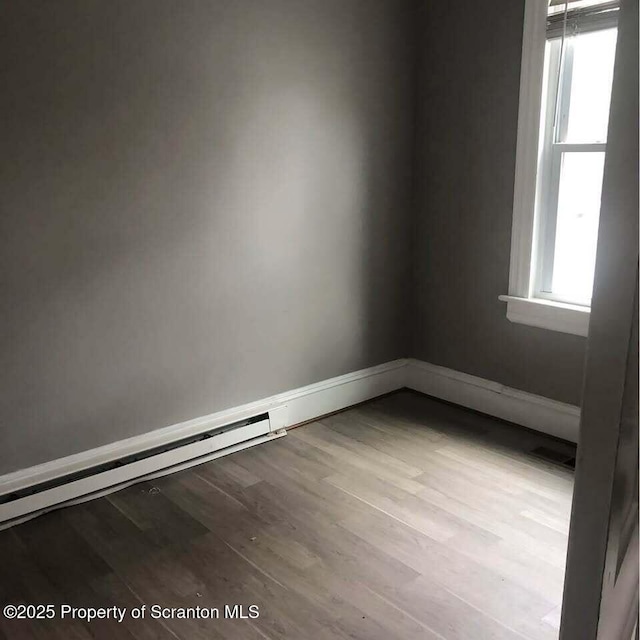 unfurnished room with light wood-type flooring