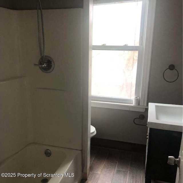 full bathroom with wood-type flooring, vanity, toilet, and a healthy amount of sunlight