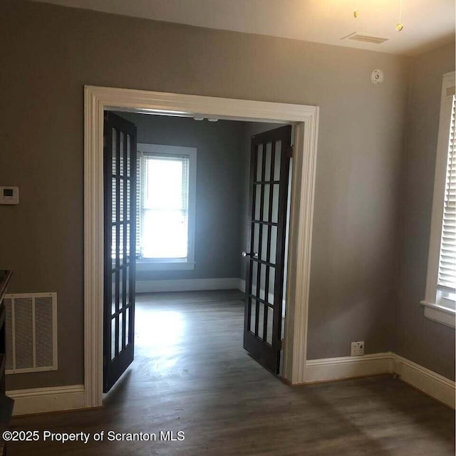 corridor with dark hardwood / wood-style floors