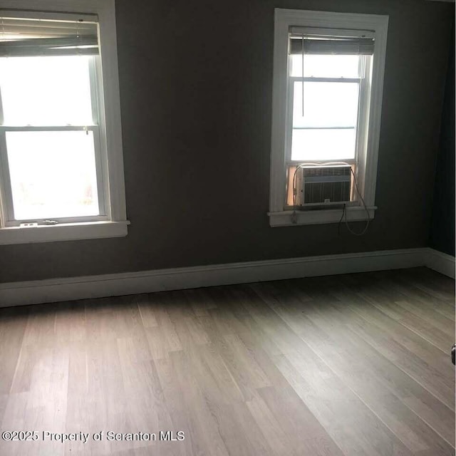 empty room featuring light hardwood / wood-style flooring and cooling unit