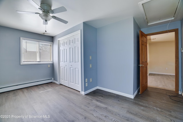 3239 Birney Ave, Scranton, PA 18505 - unfurnished bedroom with baseboard heating, attic access, baseboards, wood finished floors, and visible vents