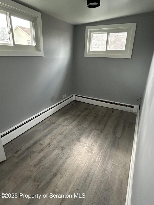 627 May St, Mayfield, PA 18433 - empty room with wood finished floors and a baseboard radiator