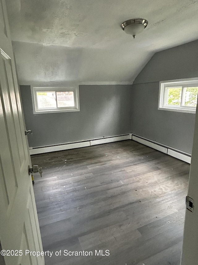 627 May St, Mayfield, PA 18433 - additional living space featuring a baseboard radiator, vaulted ceiling, and wood finished floors