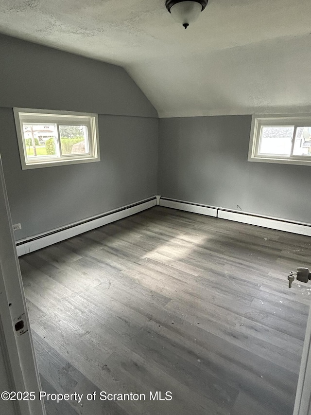 627 May St, Mayfield, PA 18433 - additional living space featuring a textured ceiling, a baseboard heating unit, wood finished floors, and lofted ceiling