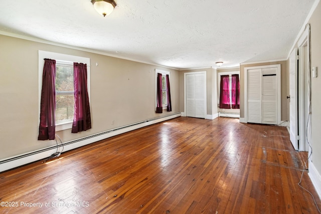 675 Apple Tree Rd, Harding, PA 18643 - unfurnished room with baseboard heating, hardwood / wood-style flooring, a textured ceiling, and crown molding