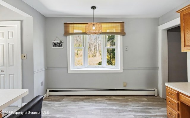 675 Apple Tree Rd, Harding, PA 18643 - unfurnished dining area featuring baseboard heating and light wood-style floors