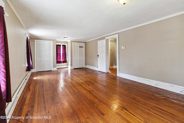 675 Apple Tree Rd, Harding, PA 18643 - unfurnished room featuring baseboard heating, crown molding, hardwood / wood-style flooring, a baseboard radiator, and a textured ceiling