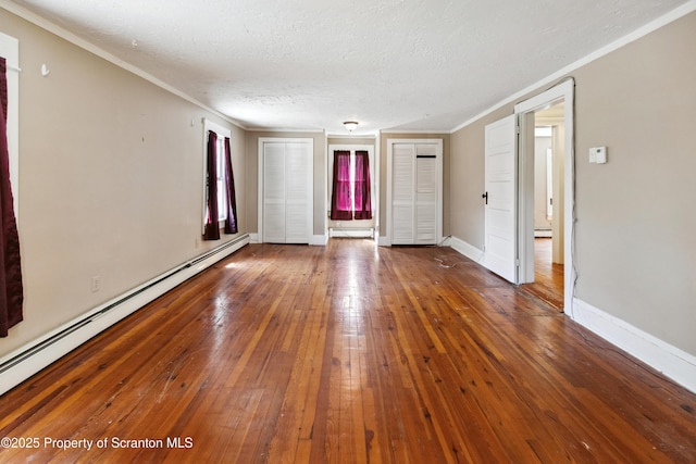 675 Apple Tree Rd, Harding, PA 18643 - unfurnished room featuring a baseboard heating unit, crown molding, wood-type flooring, and a textured ceiling
