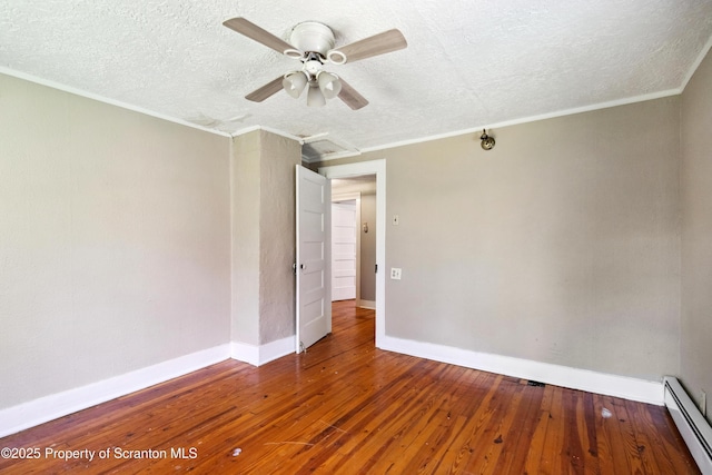 675 Apple Tree Rd, Harding, PA 18643 - empty room with baseboard heating, a textured ceiling, wood-type flooring, ornamental molding, and a ceiling fan