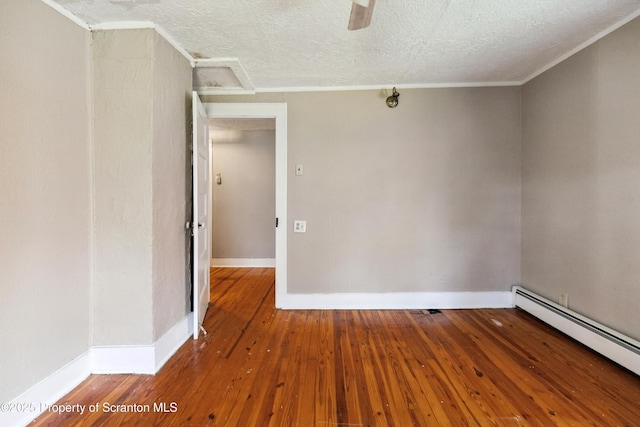 675 Apple Tree Rd, Harding, PA 18643 - spare room with a baseboard heating unit, hardwood / wood-style floors, a textured ceiling, ornamental molding, and ceiling fan